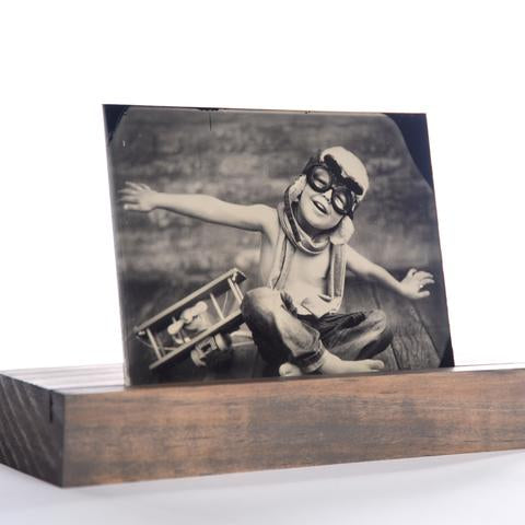 digital tintype picture of a boy and toy plane